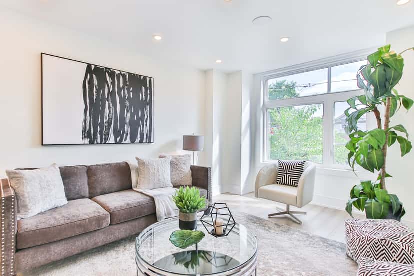 Large statement canvas spanning about two-thirds of the sofa width