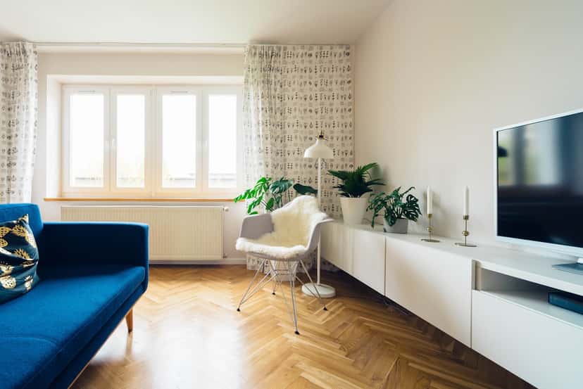Bright living room wall awaiting a large anchor canvas above the sofa